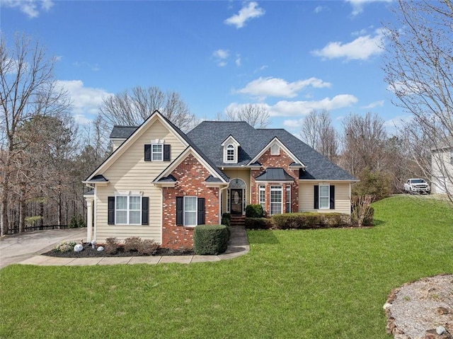 craftsman-style home with brick siding, roof with shingles, and a front lawn