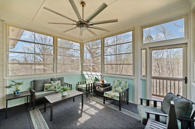 sunroom / solarium featuring ceiling fan