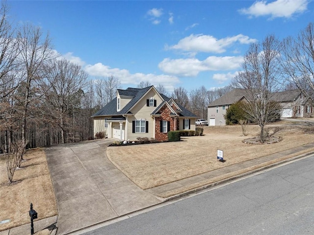 view of front of house with concrete driveway, an attached garage, brick siding, and a front lawn