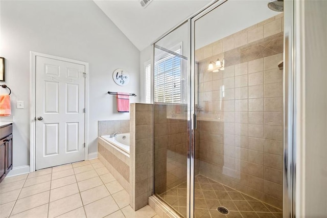 full bathroom with vanity, lofted ceiling, tile patterned flooring, a shower stall, and a garden tub