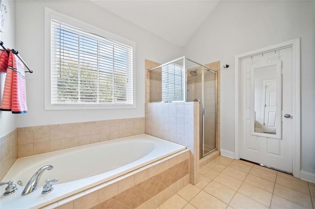 bathroom with a bath, vaulted ceiling, a shower stall, and tile patterned flooring