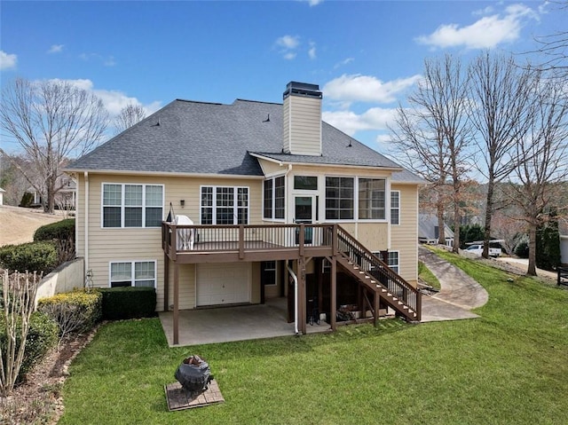 back of property with stairway, driveway, a chimney, a shingled roof, and a lawn