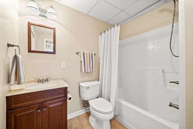 full bath with baseboards, toilet, tile patterned floors, vanity, and a paneled ceiling