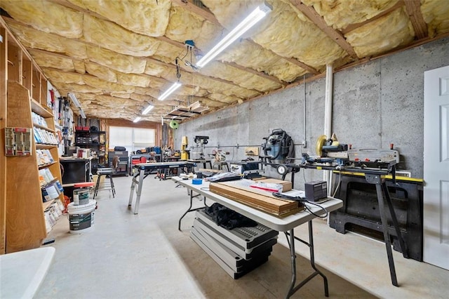 misc room with a workshop area and concrete flooring