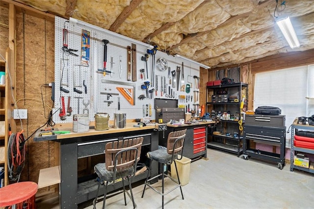 miscellaneous room featuring a workshop area and concrete flooring