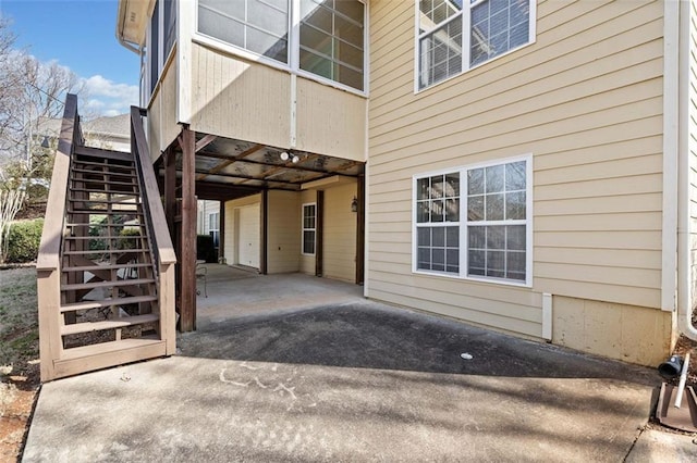 view of patio with a garage and stairs