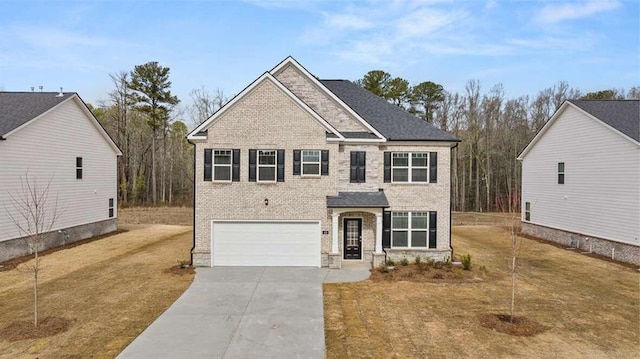 view of front facade with a front yard and a garage