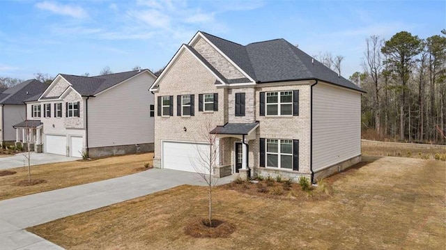 view of front facade with a garage and a front lawn