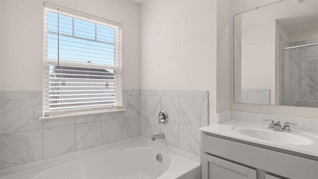 bathroom with vanity and separate shower and tub