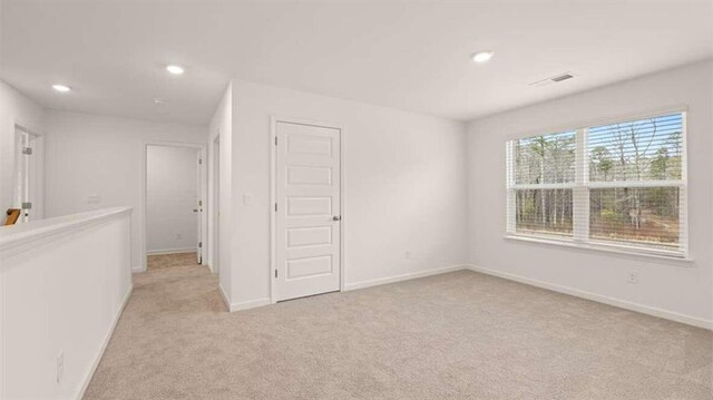 spare room with light colored carpet