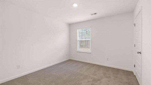 spare room with light colored carpet