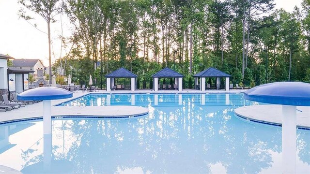 view of swimming pool with a gazebo and a patio