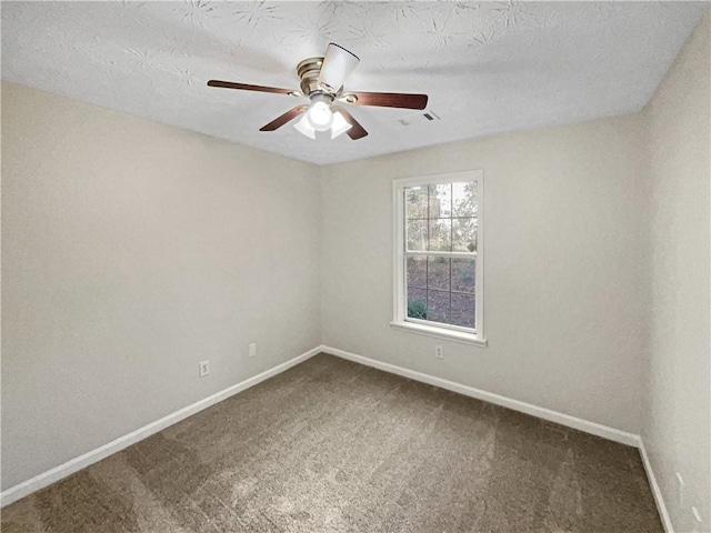 carpeted spare room with ceiling fan and a textured ceiling