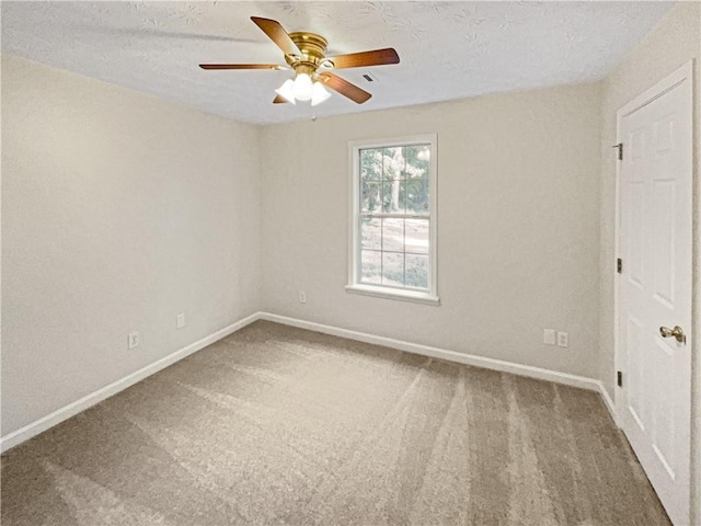 carpeted spare room with a textured ceiling and ceiling fan