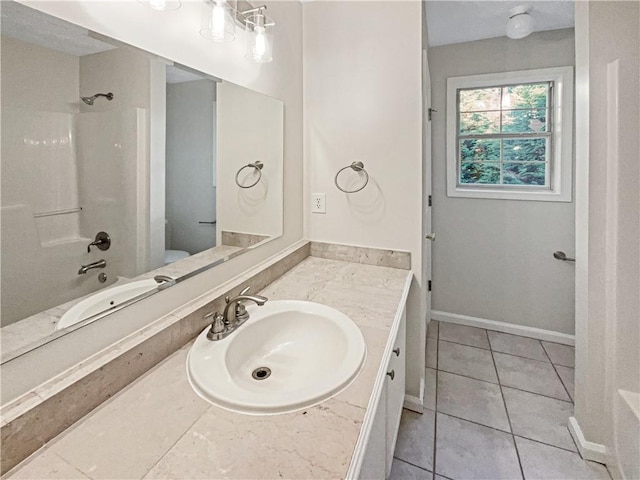 bathroom with vanity, bathing tub / shower combination, and tile patterned flooring