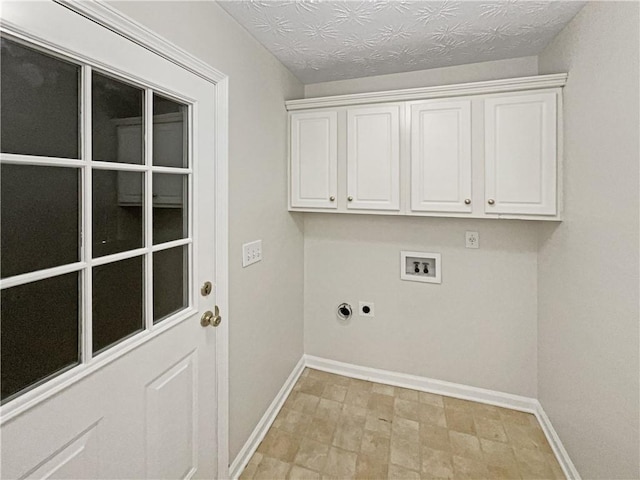 washroom with cabinets, hookup for an electric dryer, and hookup for a washing machine