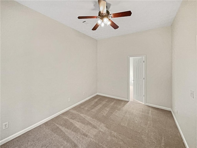 spare room with carpet floors and ceiling fan