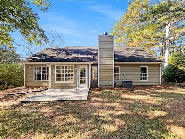 back of house with a patio, central AC unit, and a lawn