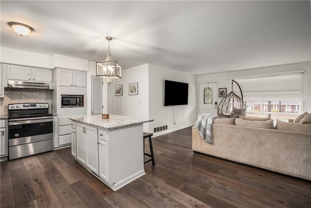 kitchen featuring white cabinetry, a kitchen island, stainless steel range with electric cooktop, and decorative light fixtures