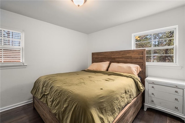 bedroom with dark wood-type flooring