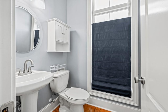 bathroom featuring sink, wood-type flooring, and toilet