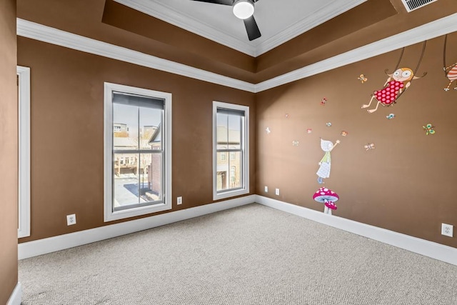 spare room featuring crown molding, carpet, and ceiling fan