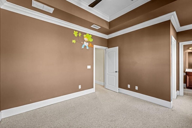 carpeted empty room featuring crown molding