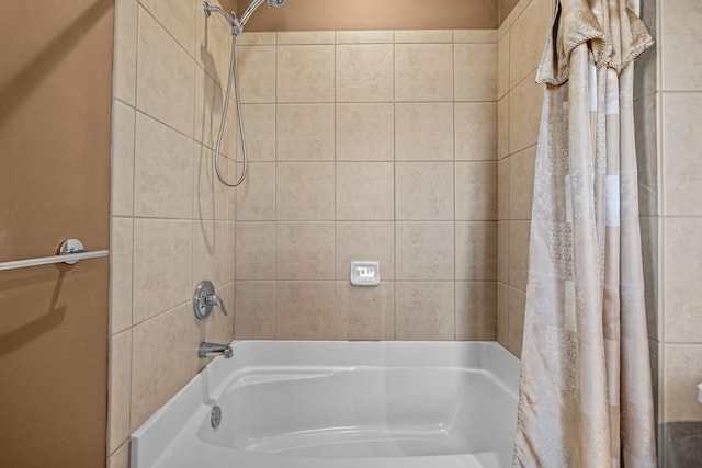 bathroom with shower / bath combo with shower curtain