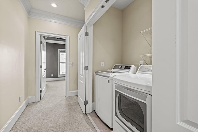 washroom featuring light colored carpet, separate washer and dryer, and crown molding