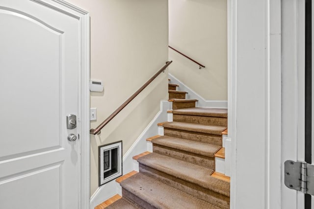 staircase with wood-type flooring