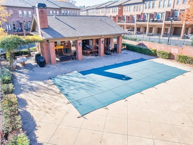 view of swimming pool featuring a patio area and a fireplace