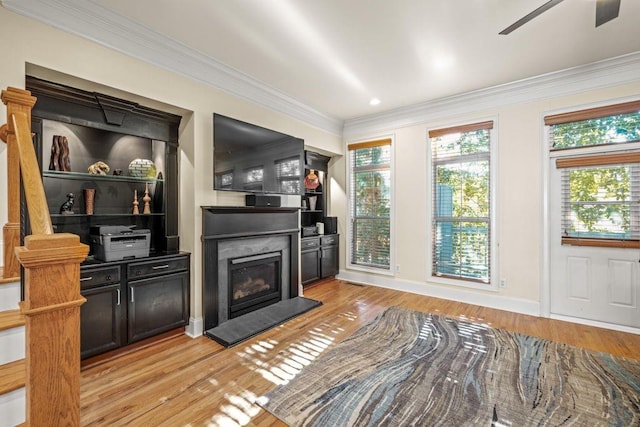 living room featuring ceiling fan, light hardwood / wood-style floors, and ornamental molding