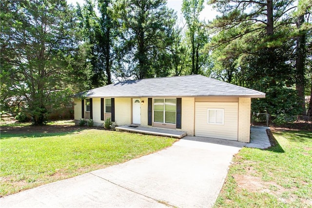 ranch-style house with a front lawn, concrete driveway, and brick siding