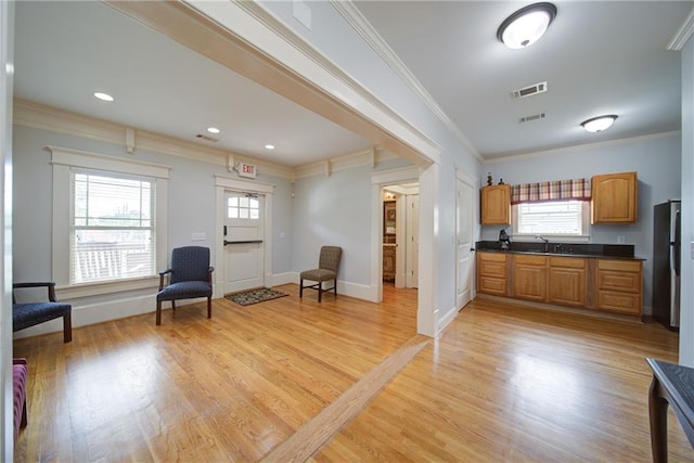 334 Glenn Abby Ln, Pendergrass, GA 30567 - kitchen featuring dark countertops, freestanding refrigerator, ornamental molding, plenty of natural light, and light wood-type flooring