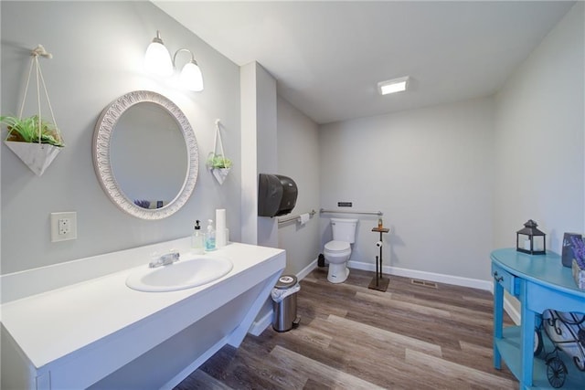 334 Glenn Abby Ln, Pendergrass, GA 30567 - bathroom with wood finished floors, toilet, baseboards, and vanity