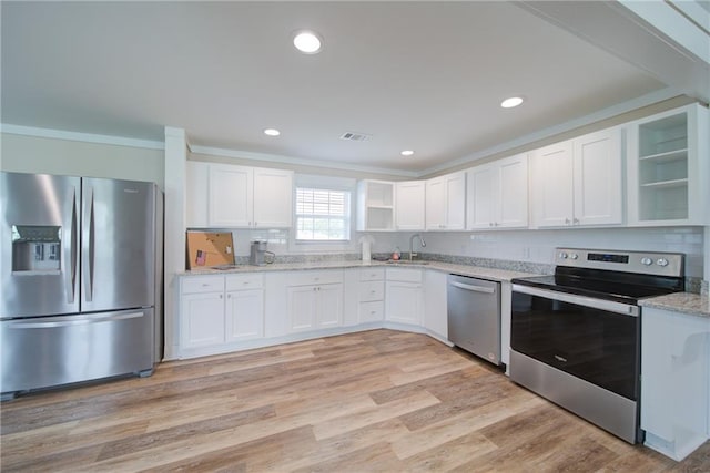 334 Glenn Abby Ln, Pendergrass, GA 30567 - kitchen with appliances with stainless steel finishes, open shelves, white cabinets, light stone countertops, and ornamental molding