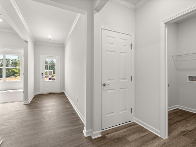 entryway with crown molding, baseboards, and dark wood-style flooring