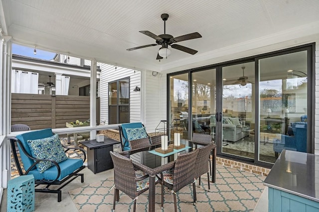 sunroom featuring a ceiling fan