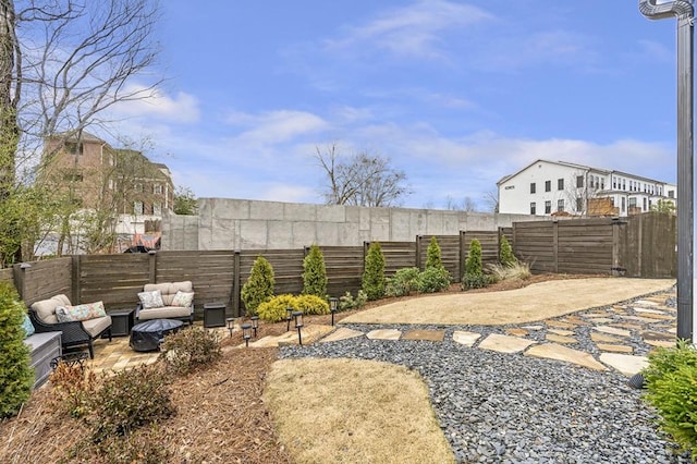 view of yard with a fenced backyard, a patio, and an outdoor hangout area