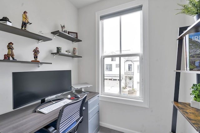 home office with carpet, a wealth of natural light, and baseboards