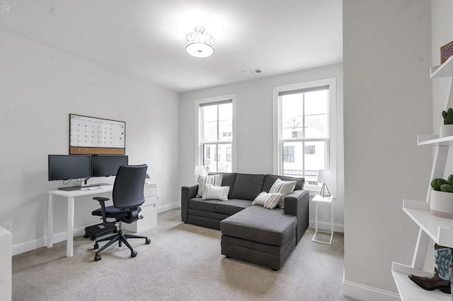 office area with carpet flooring, visible vents, and baseboards