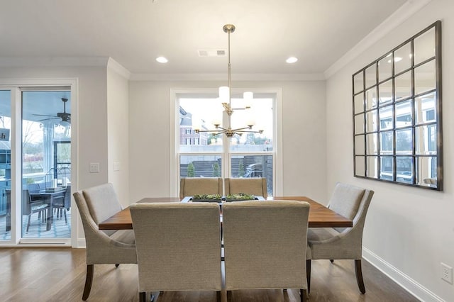 dining area featuring a wealth of natural light, visible vents, and crown molding