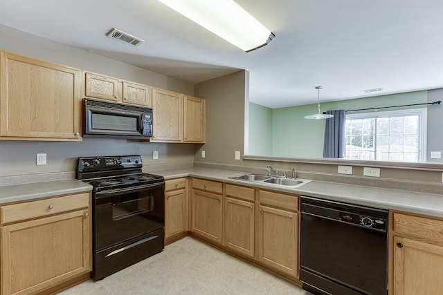 kitchen with light brown cabinets, a sink, visible vents, and black appliances