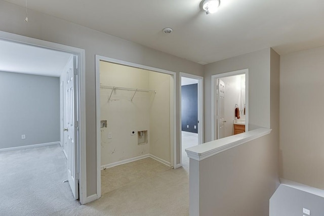 clothes washing area featuring baseboards, laundry area, hookup for an electric dryer, and light colored carpet