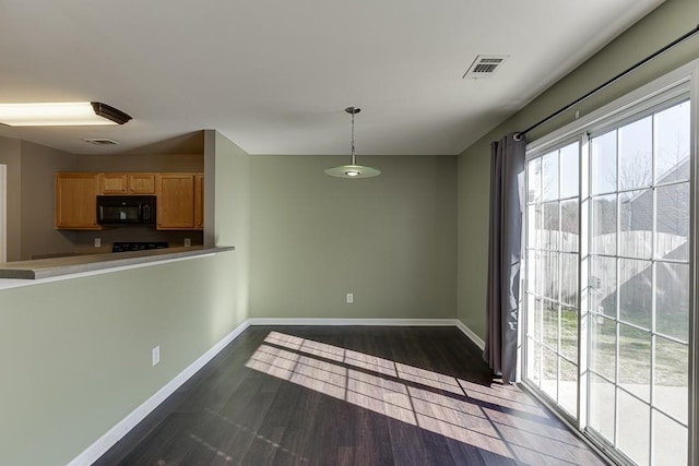 interior space with dark wood-style floors, baseboards, and visible vents