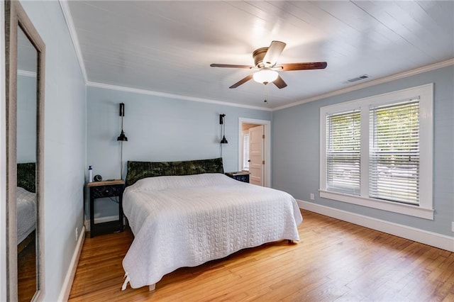 bedroom featuring ornamental molding, hardwood / wood-style flooring, and ceiling fan