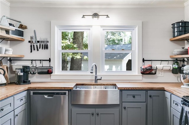 kitchen featuring butcher block counters, a wealth of natural light, sink, and dishwasher