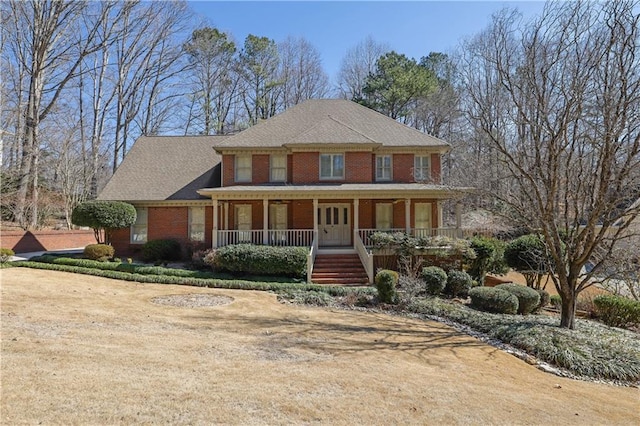 view of front of home featuring a porch and brick siding