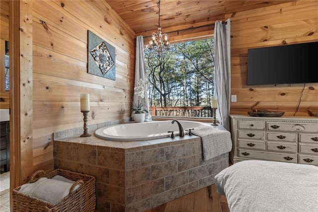 full bathroom featuring a chandelier, a bath, wood ceiling, and wooden walls