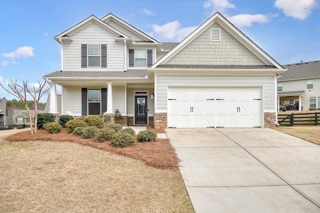 48 Ironwood Ct, Dallas, GA 30132 - craftsman-style house with stone siding, concrete driveway, fence, and a garage